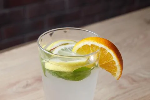 On the table, soft drinks, various cocktails, a glass with a straw and a slice Stock Photos