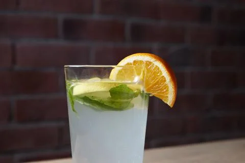 On the table, soft drinks, various cocktails, a glass with a straw and a slice Stock Photos