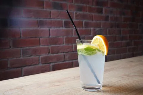On the table, soft drinks, various cocktails, a glass with a straw and a slice Stock Photos