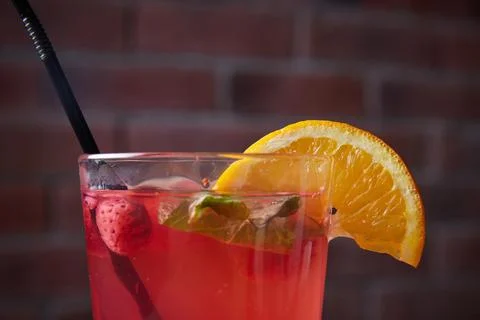 On the table, soft drinks, various cocktails, a glass with a straw and a slice Stock Photos