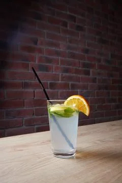 On the table, soft drinks, various cocktails, a glass with a straw and a slice Stock Photos