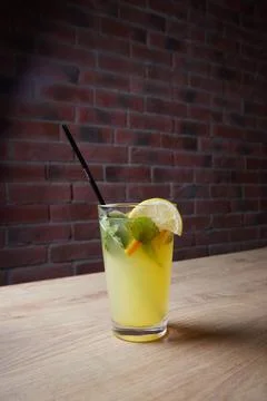 On the table, soft drinks, various cocktails, a glass with a straw and a slice Stock Photos