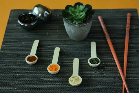 Table with spices, aromas, chopsticks, plants and Asian infusions. Stock Photos