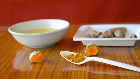 Table spoon of Pure Turmeric Haldi Powder. Anti-inflammatory and antioxidant  Stock Footage 127555446