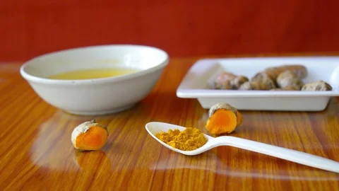 Table spoon of Pure Turmeric Haldi Powder. Anti-inflammatory and antioxidant  Stock Footage 127555450