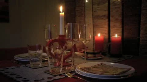 Table spread of a Christmas eve dinner by candlelight Stock Footage 12714211