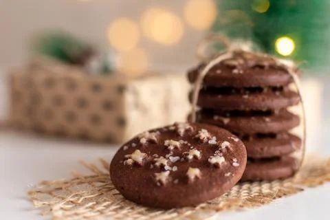 On the table is a stack of round chocolate Christmas cookies and glass of milk Stock-Fotos