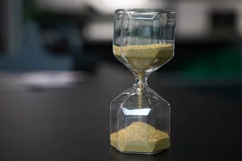 On table stand an egg timer made of glass, which is filled with small ball... Stock-Fotos