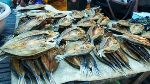 Table stand placed with brown dried fish ready to be sold. Stock Photos