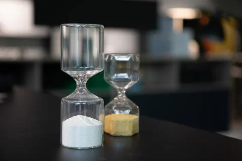 On  table stand two egg timers of different sizes Stock Photos