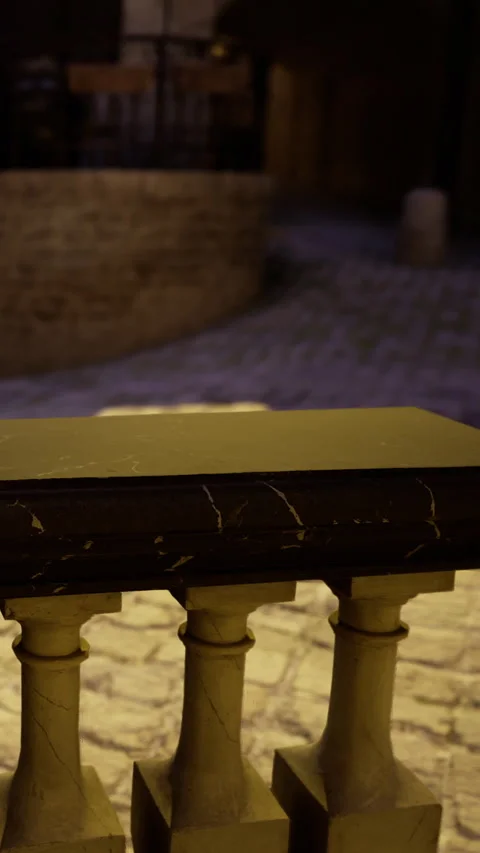 Table stands in front of a wall in a stone walkway during evening hours Stock Footage 331768260