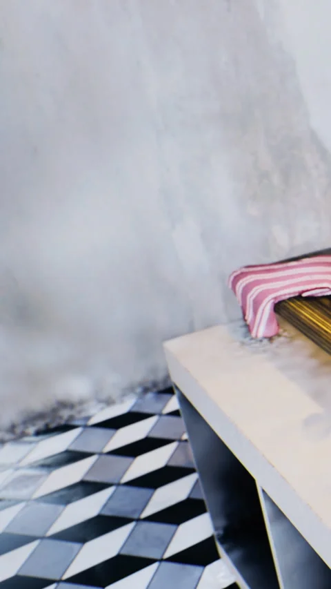 A table stands in an indoor space with a striped cloth on it Stock Footage 333564671