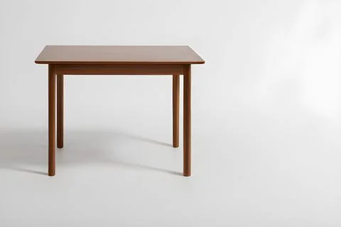 The table stands in the middle of a white room on a light white background. Stock Illustration