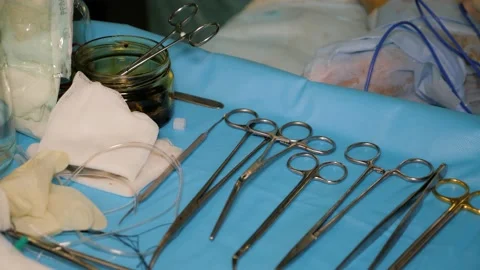 Table with sterile surgical instruments in operating theater. Stock Footage 132497030