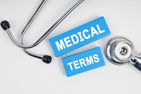 On the table is a stethoscope and blue Jenga with the inscription - MEDICAL T Stock Photos