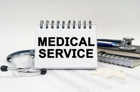 On the table is a stethoscope, a diary and a notebook with the inscription -  Stock Photos