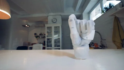 Table surface with a bionic clenched fist on it Stock Footage 100962131
