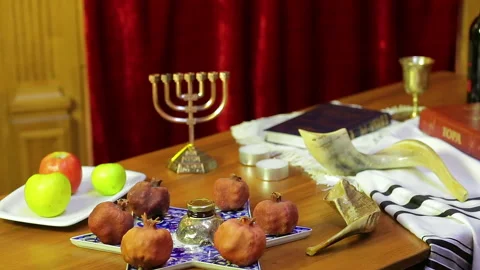 On the table in the synagogue there are symbols of Rosh Hashanah: treats, shofar Stock Footage 93665691