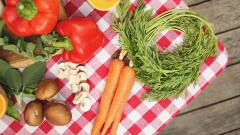 Table with tablecloth and different types of vegetables from an aerial point of  Stock Footage 91046458