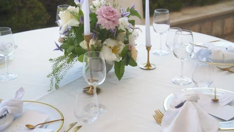 Table with tablecloth, beautiful serving of white dishes, fresh flowers, dinner Stock Footage 200975818