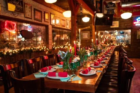 Table with tableware at the bar is beautifully set with red candles Stock Photos