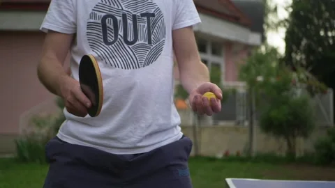 Table tennis player preparing for serve. Man player in garden setting. Slowmo. Stock Footage 130666191