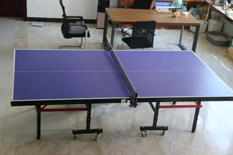 Table tennis table in a bright indoor recreation room Fotos de archivo