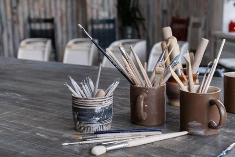 On the table there are ceramic cups with brushes Stock Photos