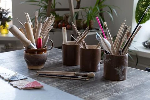 On the table there are ceramic cups with brushes Stock Photos