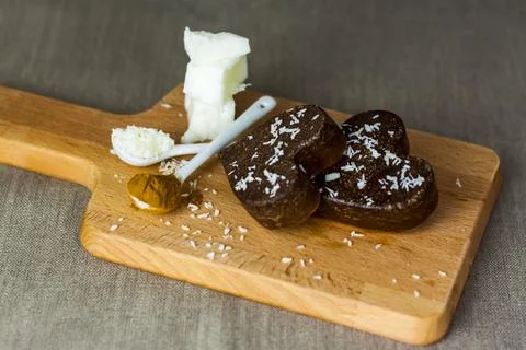 On the table there are handmade chocolates made of coconut oil, coconut chips Stock Photos