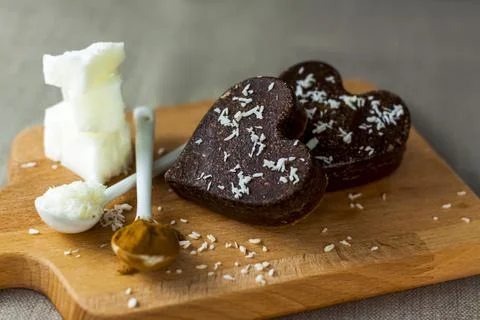 On the table there are handmade chocolates made of coconut oil, coconut chips Stock Photos