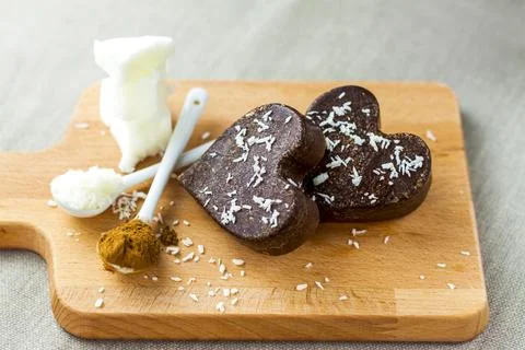 On the table there are handmade chocolates made of coconut oil, coconut chips Stock Photos