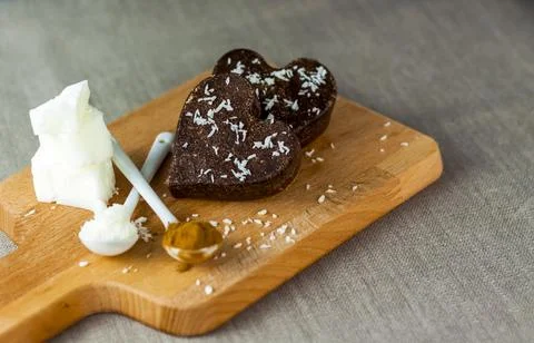 On the table there are handmade chocolates made of coconut oil, coconut chips Stock Photos