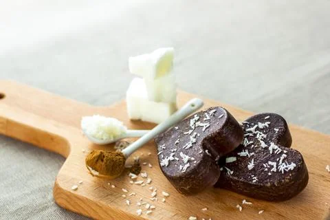 On the table there are handmade chocolates made of coconut oil, coconut chips Stock Photos