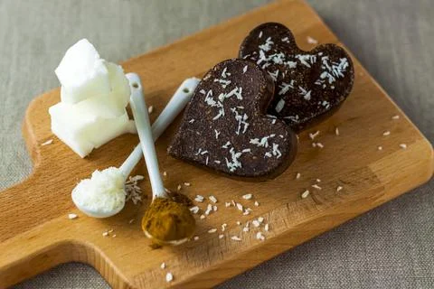 On the table there are handmade chocolates made of coconut oil, coconut chips Stock Photos