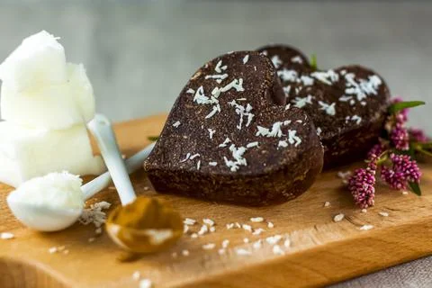 On the table there are handmade chocolates made of coconut oil, coconut chips Stock Photos