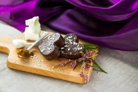 On the table there are handmade chocolates made of coconut oil, coconut chips Stock Photos