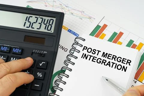 On the table there is a calculator, reports with graphs and a notepad with .. Stock-Fotos