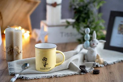 On the table there is a tea composition consisting of a yellow tin cup, a tea Stock Photos