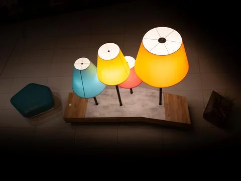 A table with three lamps on it, one of which is yellow Stock Photos