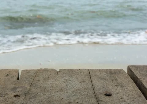 Table top with blurred background of foam waves on the beach Stock Photos
