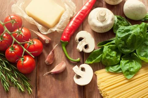 TABLE TOP FILLED WITH ASSORTED FRESH ITALIAN INGREDIENTS: BASIL,HERBS,TOMATOES Stock Photos