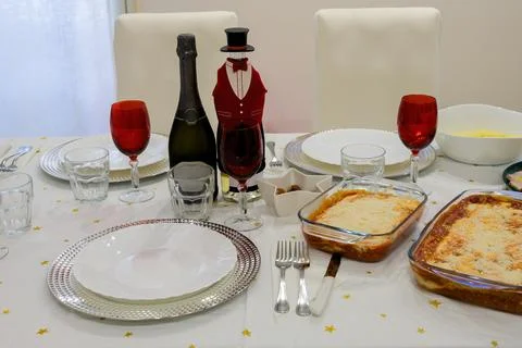 A table with a top hat shaped bottle cap and a bottle of champagne on top Stock Photos