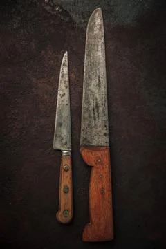 Table top of set with 2 knives on top of rusty metallic background Stock Photos