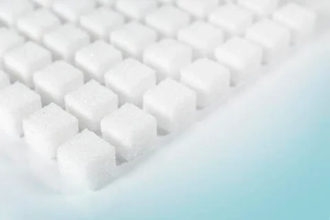 Table top shot Group of Sugar cubes vary position on light blue background Stock Photos