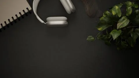 Table Top view of black desk with white over-ear headphones, spiral noteboo.. Stock Illustration