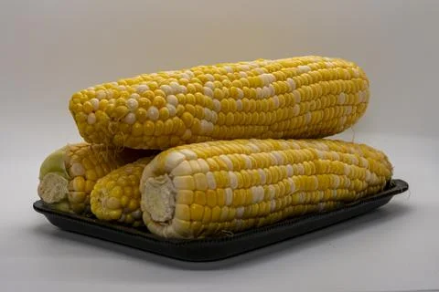 Table Top View of Corn on the Cob, Whit a White Background, in a Black Tray Stock Photos