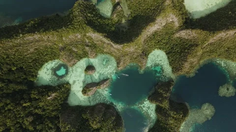 Table top view drone shot following two boats flying down to a cliffs and lagoon Stock Footage 260021487