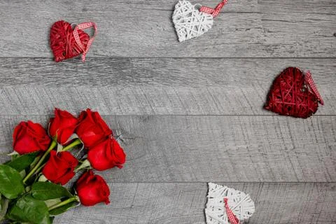 Table top view of heart decorations and red roses over gray background Stock Photos