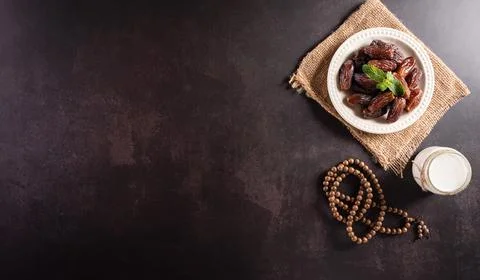 Table top view image of decoration Ramadan Kareem, dates fruit, . milk, and w Stock Photos